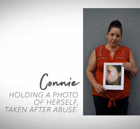 Connie holding a photo of herself taken after abuse