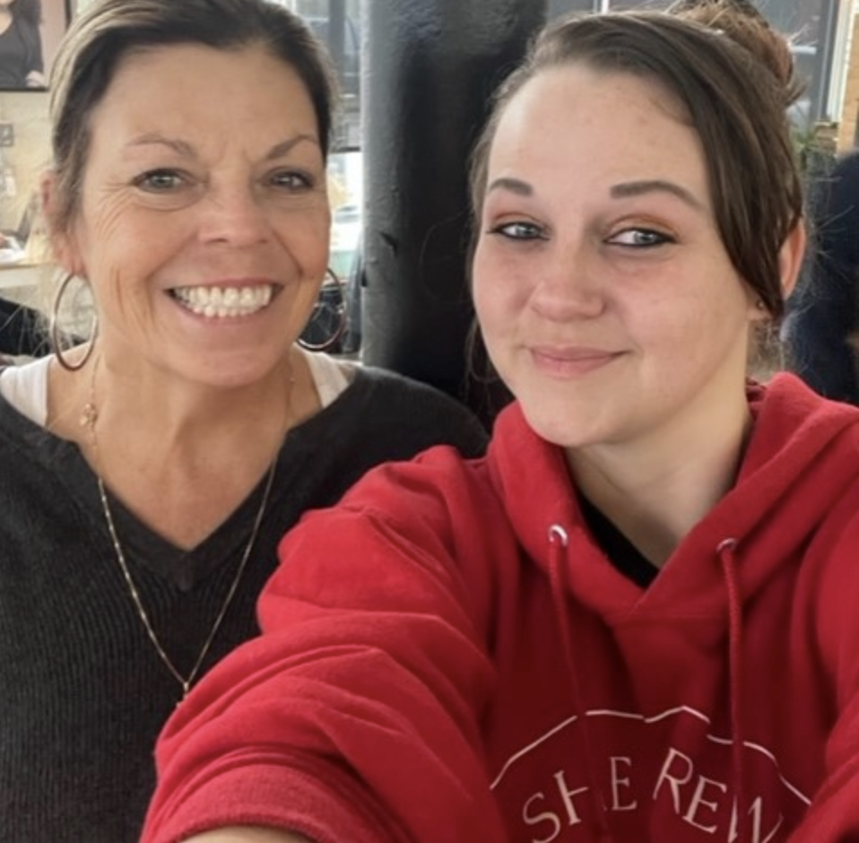 Two women smiling at the camera, selfie style